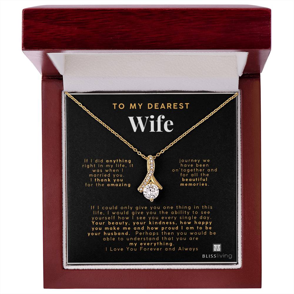 Image shows a pendant necklace for My Dearest Wife with a heartfelt message on a black background in a Mahogany Style Luxury Box on BlissLiving.com.